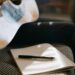 Close-up of an acoustic guitar and notebook, capturing a calm songwriting moment.